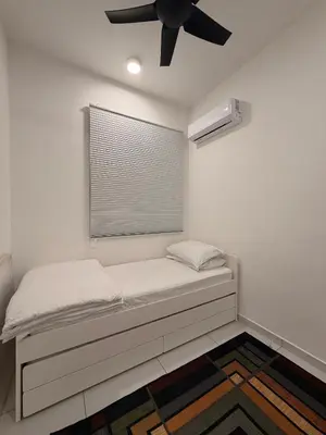 a bed in a room with a ceiling fan at Doksini in Simpang Ampat