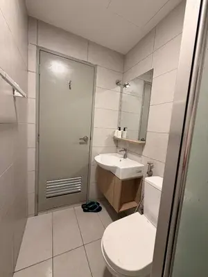 a bathroom with a toilet and a sink at Doksini in Simpang Ampat