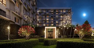 a building at night with bushes and trees and lights at Stallionz Ipoh by ANGO in Ipoh