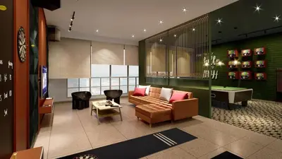 a living room with a couch and a pool table at Stallionz Ipoh by ANGO in Ipoh