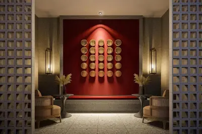 a room with a red wall with a painting on the wall at Stallionz Ipoh by ANGO in Ipoh