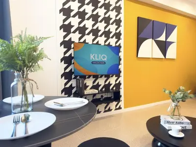 a dining room with two tables and a kalo sign on the wall at Stallionz Leisure Suites Ipoh in Ipoh