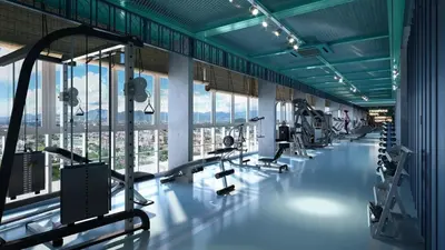 a gym with several treadmills and machines in a building at Stallionz Leisure Suites Ipoh in Ipoh