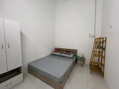 a small bedroom with a bed and a ladder at LAMAN SUZY Seri Iskandar in Seri Iskandar