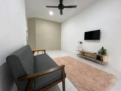 a living room with a couch and a flat screen tv at LAMAN SUZY Seri Iskandar in Seri Iskandar