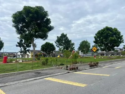 an empty road with a street sign and trees at LAMAN SUZY Seri Iskandar in Seri Iskandar