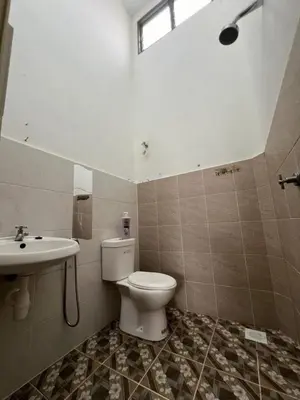 a bathroom with a toilet and a sink at LAMAN SUZY Seri Iskandar in Seri Iskandar