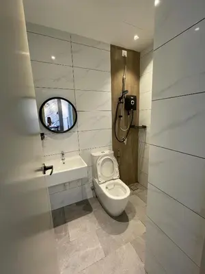 a bathroom with a toilet and a sink and a mirror at Piccadilly Greentown Ipoh in Ipoh