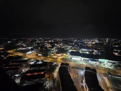 a city lit up at night with cars on the street at Piccadilly Greentown Ipoh in Ipoh