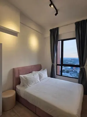 a bedroom with a bed and a large window at Piccadilly Greentown Ipoh in Ipoh