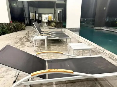 a row of chairs and tables in a building at Elegant 3BR Luxury City View Comfortable for 10 in George Town