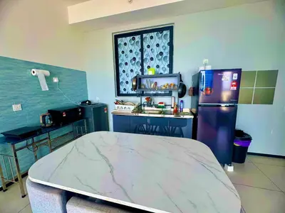 a kitchen with a refrigerator and a sink at Elegant 3BR Luxury City View Comfortable for 10 in George Town