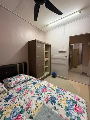 a bedroom with a bed and a ceiling fan at PRS Homestay in Chemor