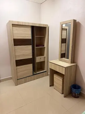a bathroom with a wooden cabinet and a mirror at PRS Homestay in Chemor