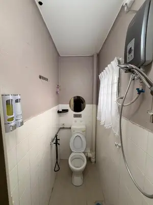 a small bathroom with a toilet and a shower at PRS Homestay in Chemor