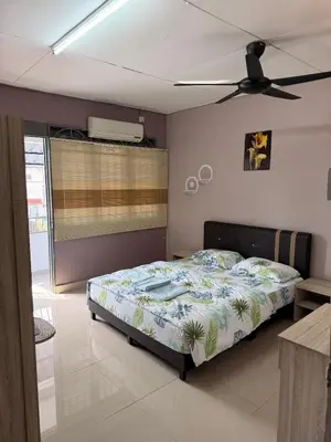 a bedroom with a bed and a ceiling fan at PRS Homestay in Chemor