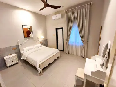 a bedroom with a white bed and a window at Ipoh Santorini Pool Villa 4BR 15pax by One Life Four Season Guesthouse in Ipoh