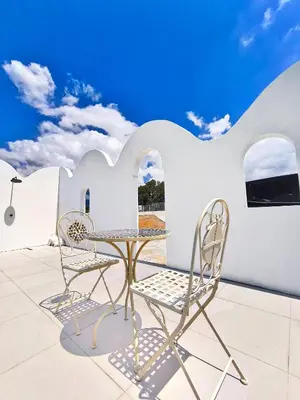 a table and two chairs on a patio at Ipoh Santorini Pool Villa 4BR 15pax by One Life Four Season Guesthouse in Ipoh