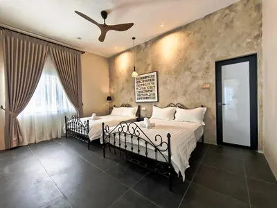 a bedroom with two beds and a ceiling fan at Ipoh Santorini Pool Villa 4BR 15pax by One Life Four Season Guesthouse in Ipoh
