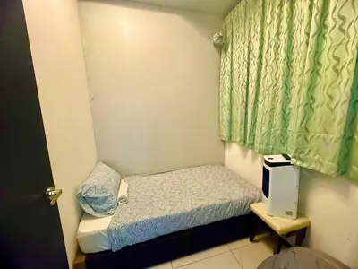 a small bedroom with a small bed and a window at Luxury 3BRHighFloor CityView10 Pax StylishSpacious in George Town