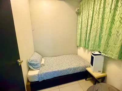 a small bedroom with a small bed and a window at Luxury 3BRHighFloor CityView10 Pax StylishSpacious in George Town