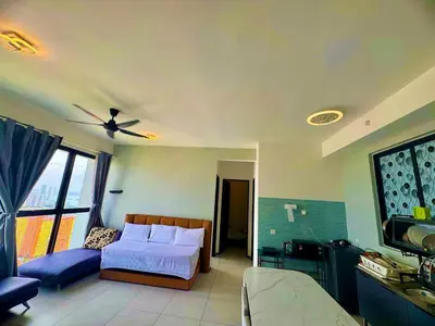 a bedroom with a bed and a flat screen tv at Luxury 3BRHighFloor CityView10 Pax StylishSpacious in George Town