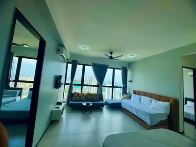 a room with a bed and a couch and windows at Luxury 3BRHighFloor CityView10 Pax StylishSpacious in George Town