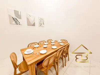 a dining room with a wooden table and chairs at Ipoh Gunung Lang Mooncave Spacious 4BRHouse with 5 Queen Beds in Ipoh