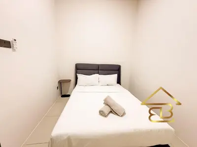 a white bedroom with a bed with a black headboard at Ipoh Gunung Lang Mooncave Spacious 4BRHouse with 5 Queen Beds in Ipoh