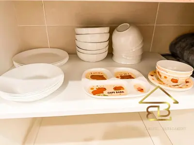 a white shelf with plates and bowls on it at Ipoh Gunung Lang Mooncave Spacious 4BRHouse with 5 Queen Beds in Ipoh