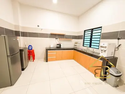 a kitchen with a refrigerator and a counter top at Ipoh Gunung Lang Mooncave Spacious 4BRHouse with 5 Queen Beds in Ipoh