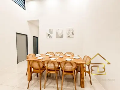 a dining room with a wooden table and chairs at Ipoh Gunung Lang Mooncave Spacious 4BRHouse with 5 Queen Beds in Ipoh