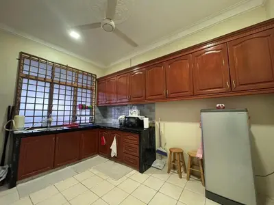 a kitchen with wooden cabinets and a refrigerator at Amiradanial Homestay in Gua Musang