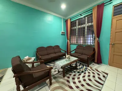 a living room with a couch and a table at Amiradanial Homestay in Gua Musang