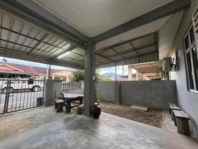 an outdoor patio with a table and benches at Amiradanial Homestay in Gua Musang