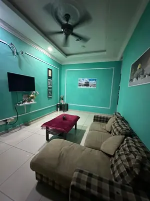 a living room with a couch and a flat screen tv at RSyifaris ZH Homestay DSerai Wangi