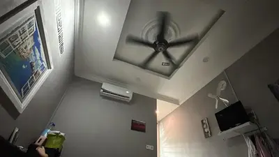 a clock on the ceiling of a room at RSyifaris ZH Homestay DSerai Wangi