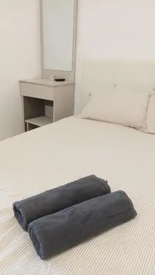 a blue pillow sitting on top of a bed at Rara Homestay in Kampong Selamat