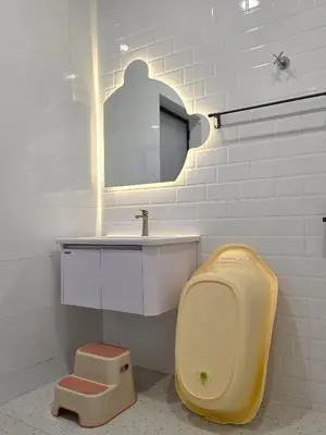 a bathroom with a toilet with a sink and a mirror at Kidello Home Ipoh Indoor Private Playground in Ipoh