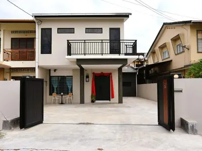 a house with a red garland on the front of it at Kidello Home Ipoh Indoor Private Playground in Ipoh