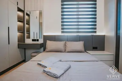 a bedroom with a large bed with two towels on it at Ipoh Midtown 33 Funhouse by Verve in Ipoh