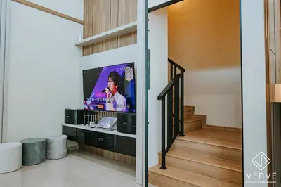 a living room with a tv on a wall at Ipoh Midtown 33 Funhouse by Verve in Ipoh