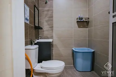 a bathroom with a toilet and a trash can at Ipoh Midtown 33 Funhouse by Verve in Ipoh