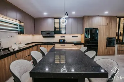 a kitchen with a black table and chairs at Ipoh Midtown 33 Funhouse by Verve in Ipoh