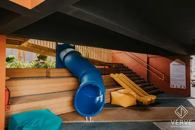 a playground with a blue slide and benches at Ipoh Town Piccadilly Premium Suites by Verve 3B2B in Gua Sai