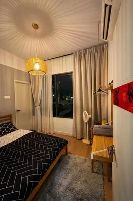 a bedroom with a bed and a large window at Private Apartment in Kuala Lumpur in Gua Sai