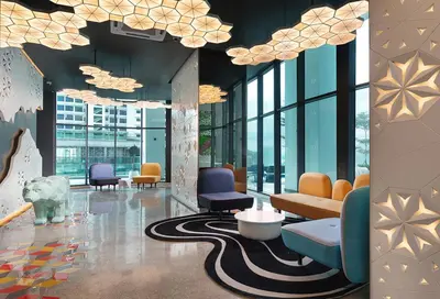 a lobby with couches and chairs in a building at Private Apartment in Kuala Lumpur in Gua Sai