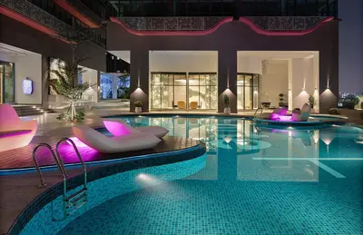 a large swimming pool with chairs and a swimming pool at Private Apartment in Kuala Lumpur in Gua Sai