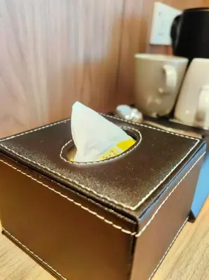 a brown box with a paper boat on top of it at 118 Grand Hotel in George Town