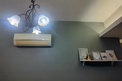 a chandelier hanging from a wall with a shelf at Kinta Olive in Ipoh